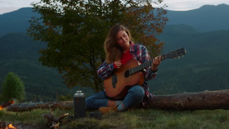 Closeup-musical-traveler-perform-song-play-acoustic-guitar-in-mountains-nature.