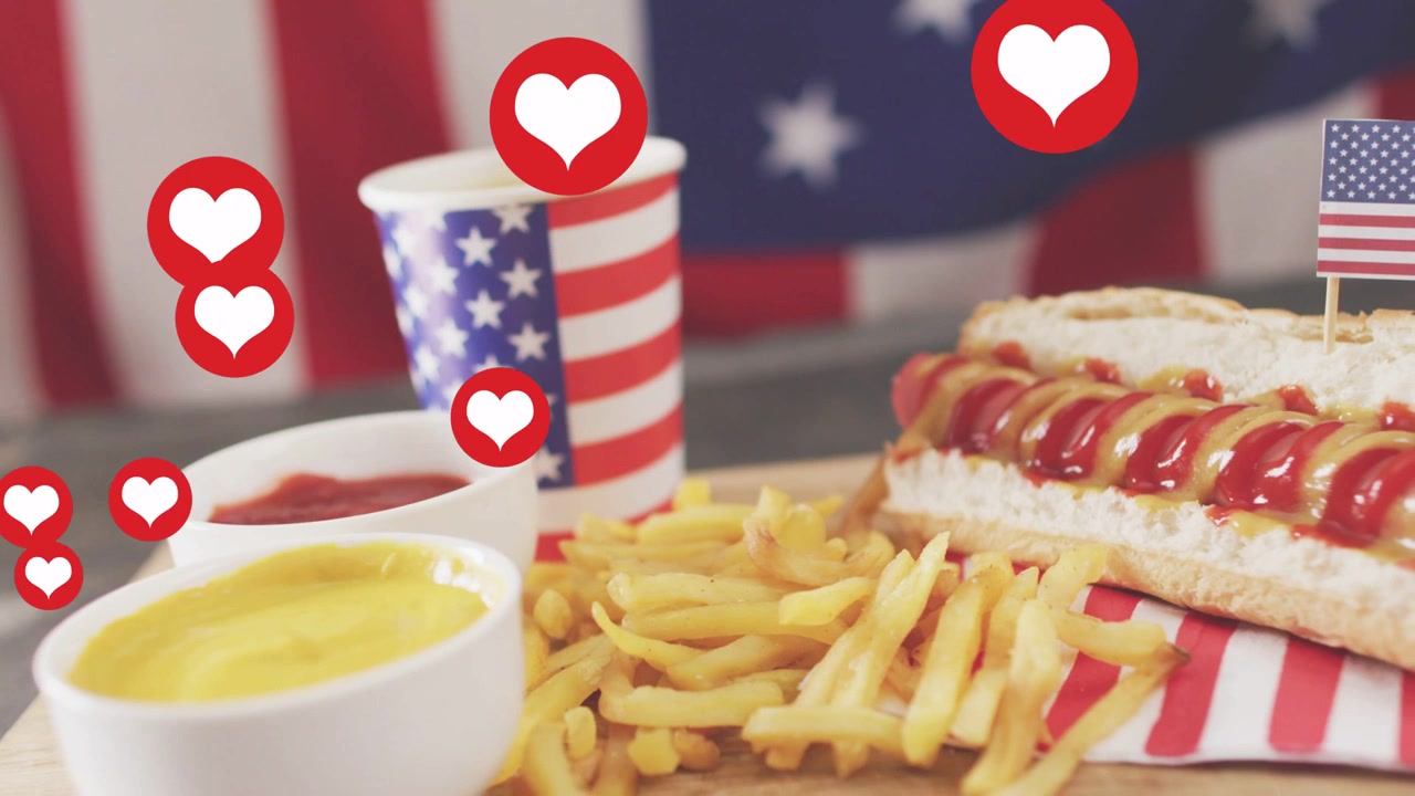 Cuori rossi animati che appaiono da sinistra e salgono sopra un pasto americano, celebrando un sapore patriottico.