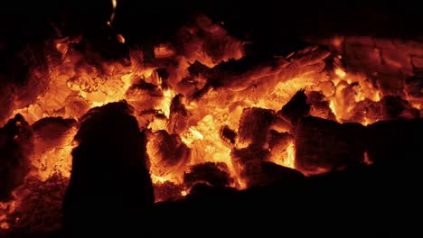 wind blowing across the coals of a burnt out campfire