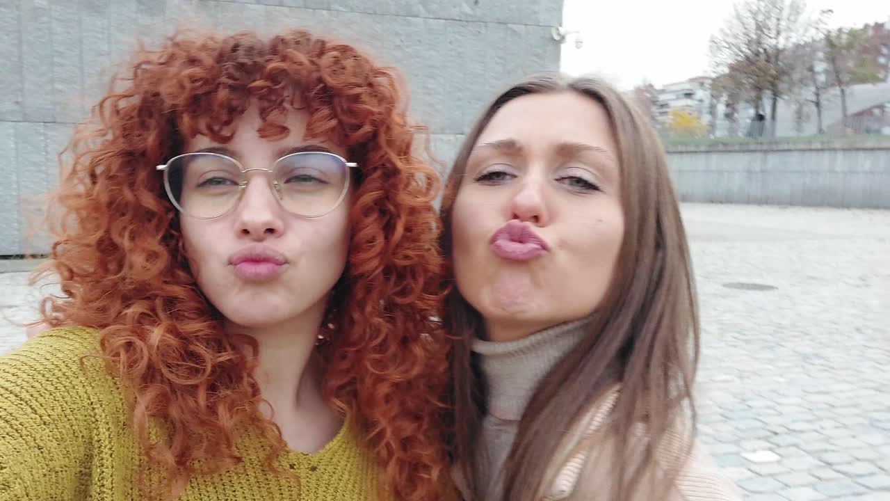 Friends pulling faces while taking a funny selfie outdoors