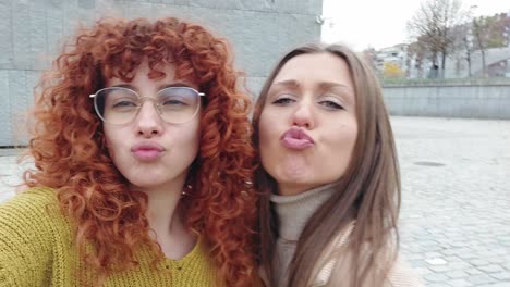 Friends pulling faces while taking a funny selfie outdoors