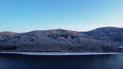 Cars-Traveling-Down-Road-In-Snow-Covered-Hills-Small-Japanese-Town