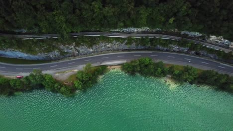 aerial view of a mountain road along the shoreline of lake mondsee, sankt lorenz, austria