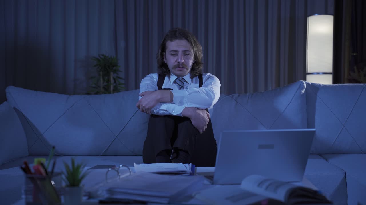 Unhappy, depressed man is thoughtful and not feeling well at home.