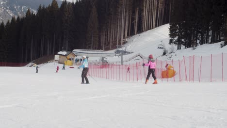 beginner skier with teacher on easy ski slope in the italian alps 4k slow motion