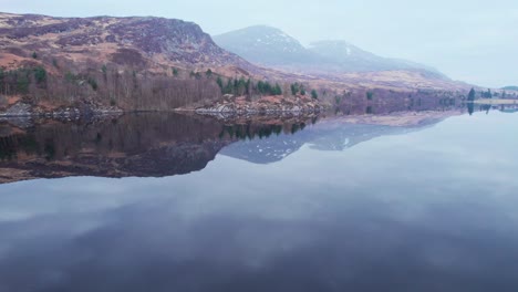 Aerial-drone-view-of-Loch-Lochy-in-Spean-Bridge,-Scotland,-pan-reveals-landscape