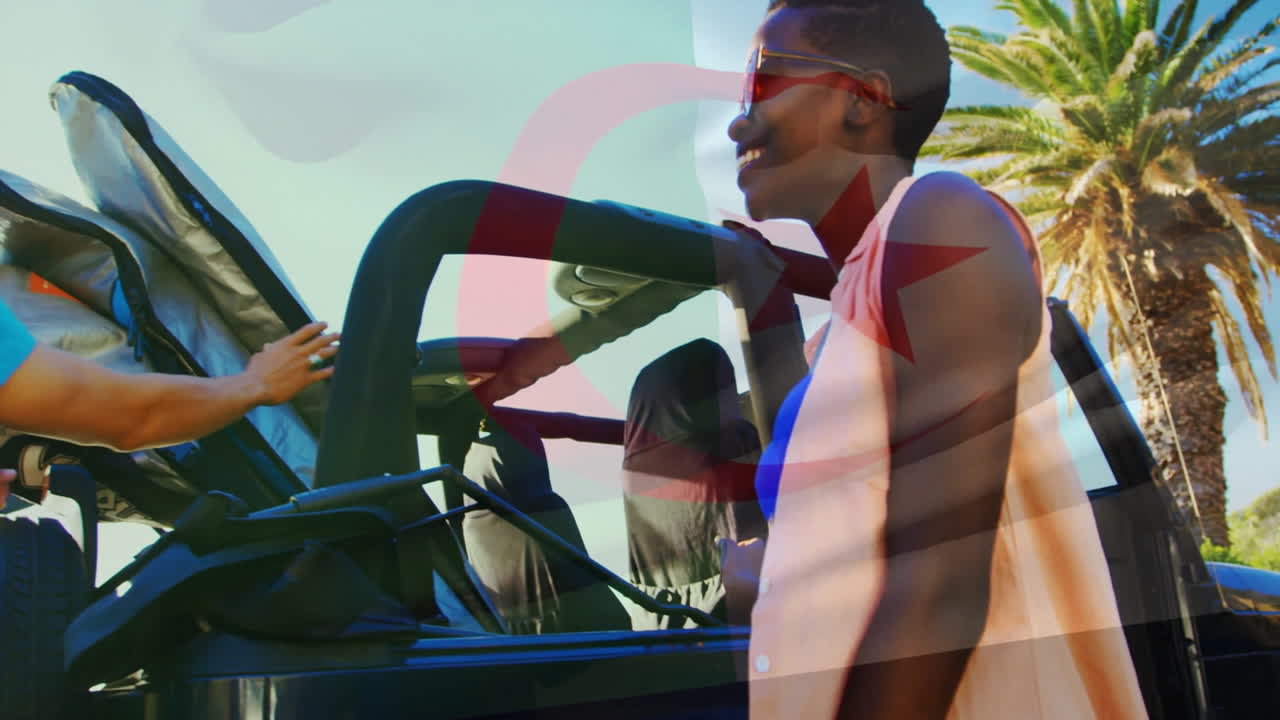 Loading surfboards onto car, people with Tunisian flag animation overlaying scene