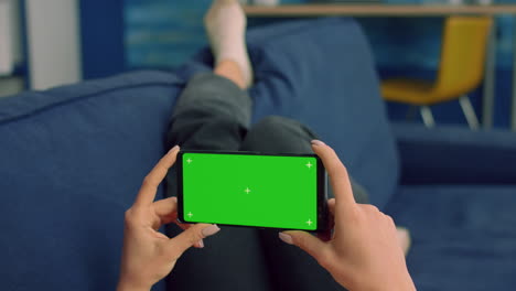 business woman lying on sofa holding isolated phone