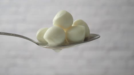 mozzarella balls on a spoon