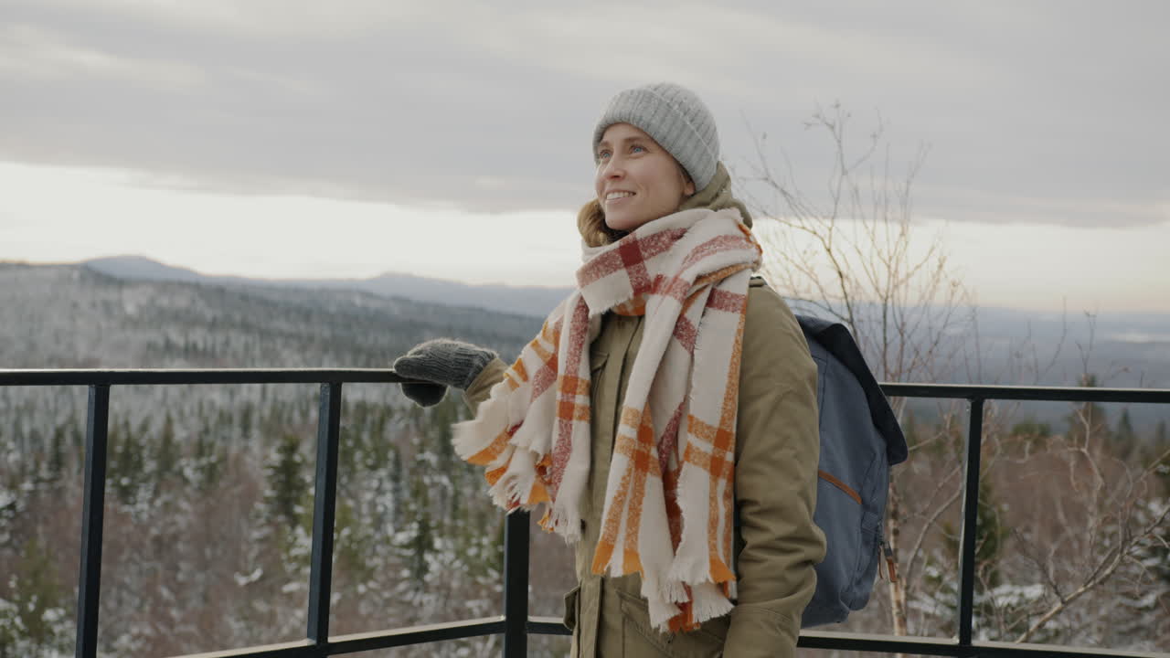 Woman enjoying a winter mountain view