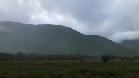 panorama of mountainous landscape in fog in countryside of scotland