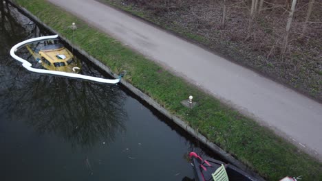 Aerial-track-shot-of-sunken-speedboat-docking-at-Harbor-With-Debris-during-daytime