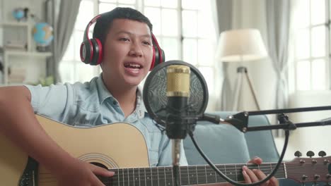 teenager singing and playing acoustic guitar
