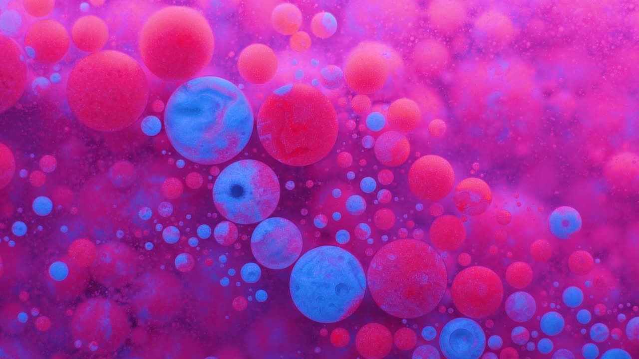 Slow Motion Bright Neon Color Bubbles Oil Beautiful Fluorescent Paint Sparkling Color Moving Multicolor Close up. Acrylic Neon Paint. Fantastic Surface. Abstract Colorful Transformation Gravitation.