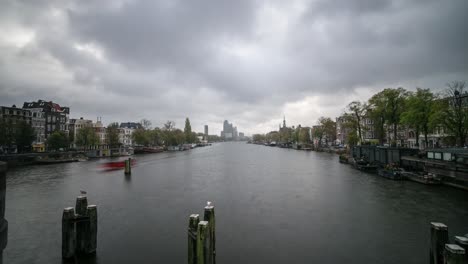 timelapse video of the amstel river leading in to amsterdam. in the distance, the amstel towers and amstel district can be seen.