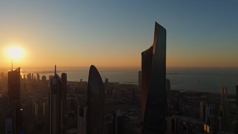 breathtaking 4k aerial view of kuwait city skyline at sunrise, capturing golden light on modern towers and calm sea. ideal for cinematic visuals, travel, or city transitions.