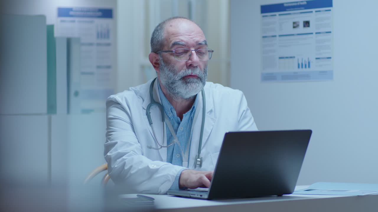 Doctor working on laptop in hospital office