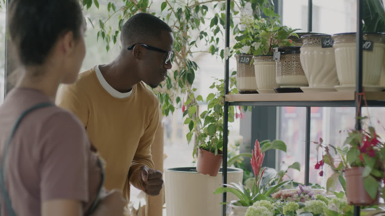 Couple Browsing Plants at a Flower Shop