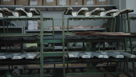 sandal soles on a conveyor amidst shoe factory production line equipment