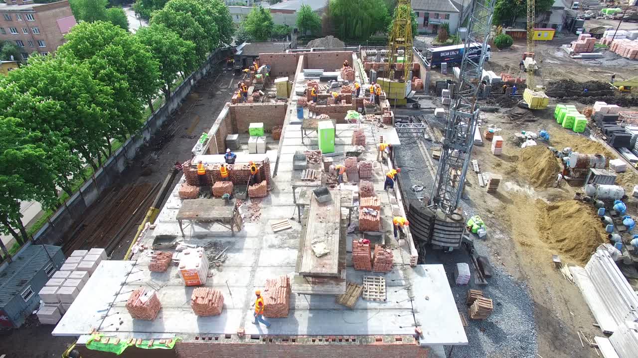 Construction Site In The City Aerial View. VINNITSA, UKRAINE - JUNE 2016: Aerial shot of the men working at construction site seen from above