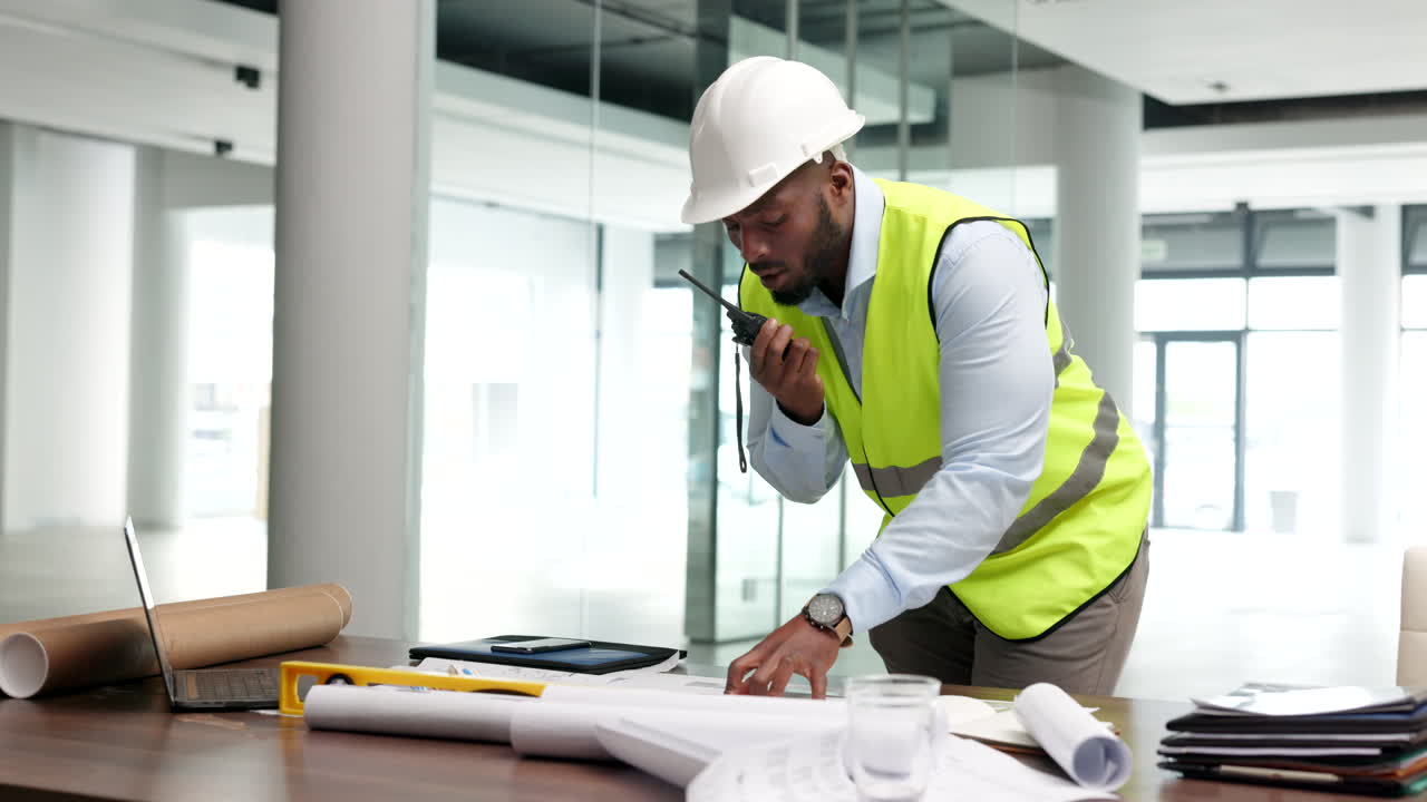 Construction worker reviewing blueprints