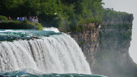 fabulously beautiful niagara falls in the background a viewing platform where tourists walk