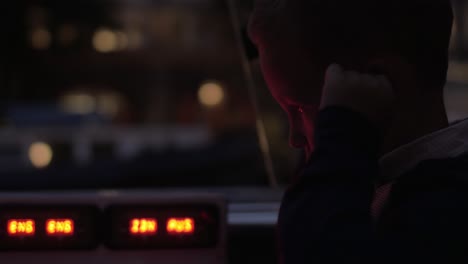 child with audioguide earphones traveling by boat in night amsterdam