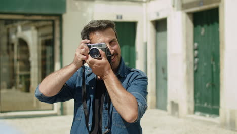 front view of happy man taking picture to his boyfriend in street