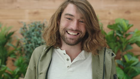 portrait of relaxed young caucasian man laughing cheerful at camera enjoying carefree lifestyle