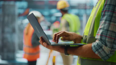 construction worker using laptop on site
