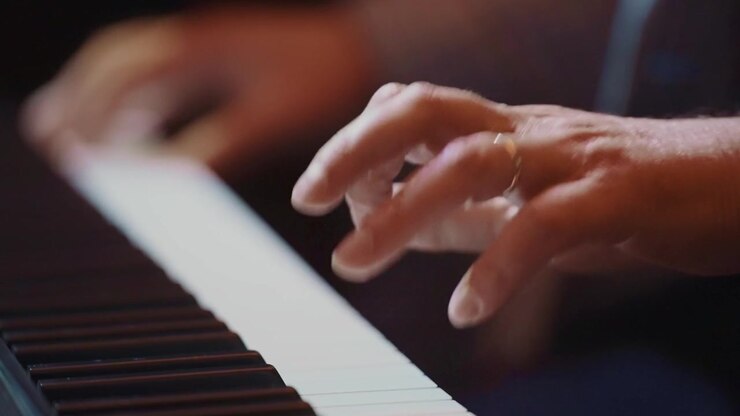 Close-up of Mature Man Playing Piano