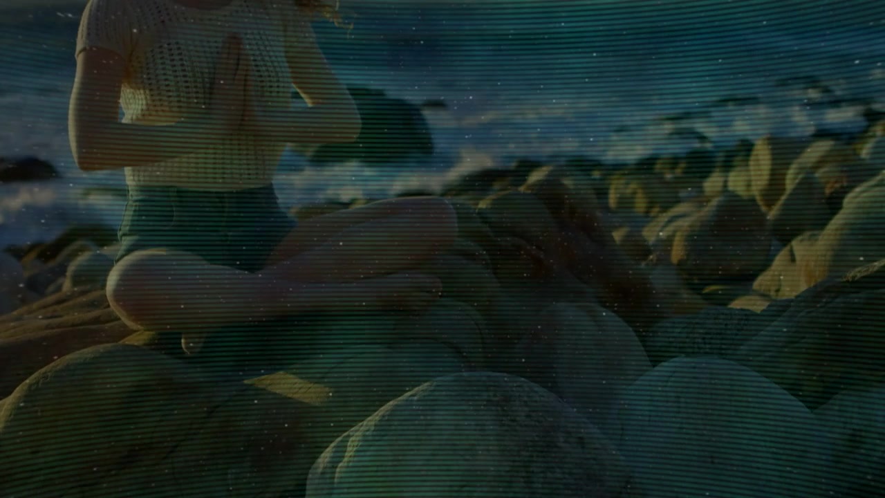 Woman meditating cross-legged on rocks, sparkle appearing causing HUD star revealing hands praying
