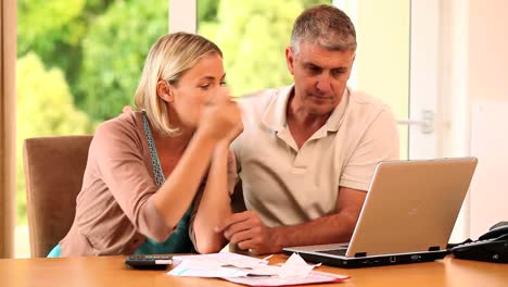 Man-reassuring-his-wife-about-bills