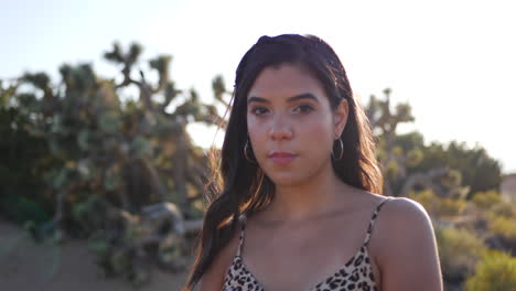 A-beautiful-woman-with-a-serious-stare-modeling-and-posing-outdoors-in-a-desert-nature-landscape