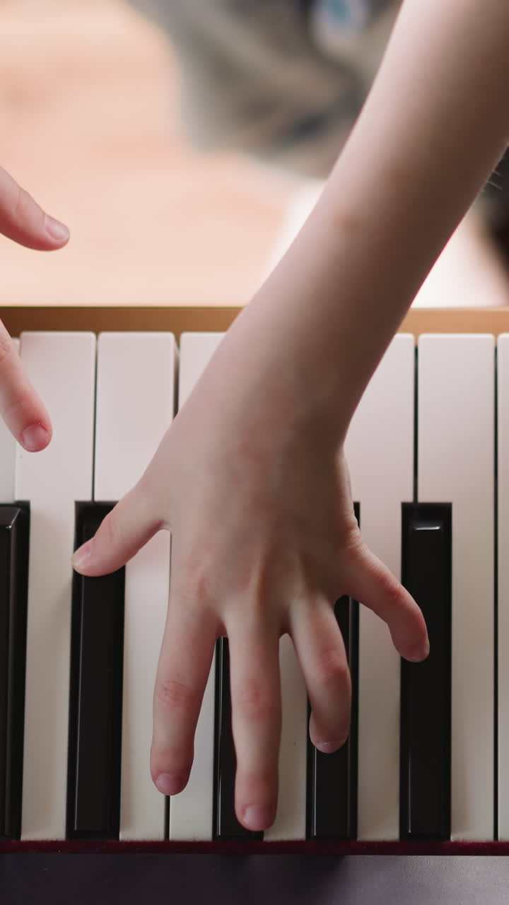 Student of music school studies types of musical articulation. Girl practices performing composition with staccato upper view on blurred background