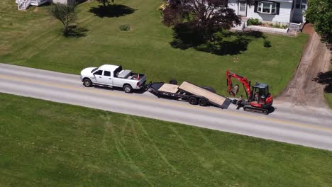 a small businessman loads up construction equipment to the trailer by truck-1