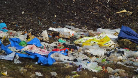 Stack-of-different-types-of-large-garbage-dump,-plastic-bags,-and-landfill-full-of-trash,-environmental-pollution,-medium-shot