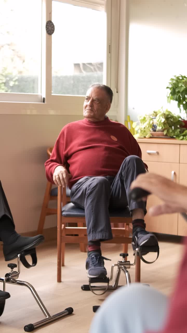 Senior people exercising with bike pedals in retirement home