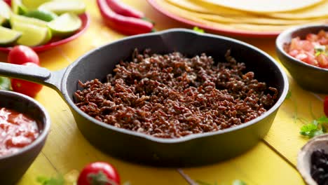 various fresh and tasty ingredients for chilli con carne  with meat on iron pan