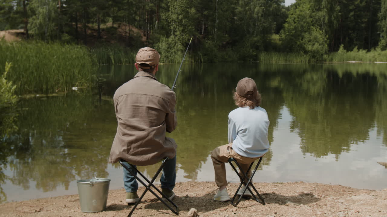 Father and Son Fishing by the Lake