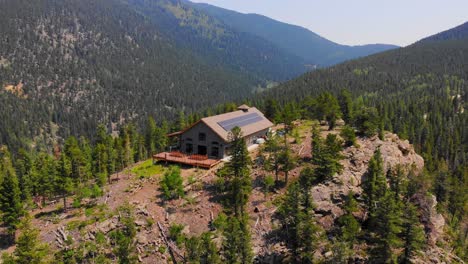 lonely isolated house cabin on vast alpine woodlands mountain hill peak