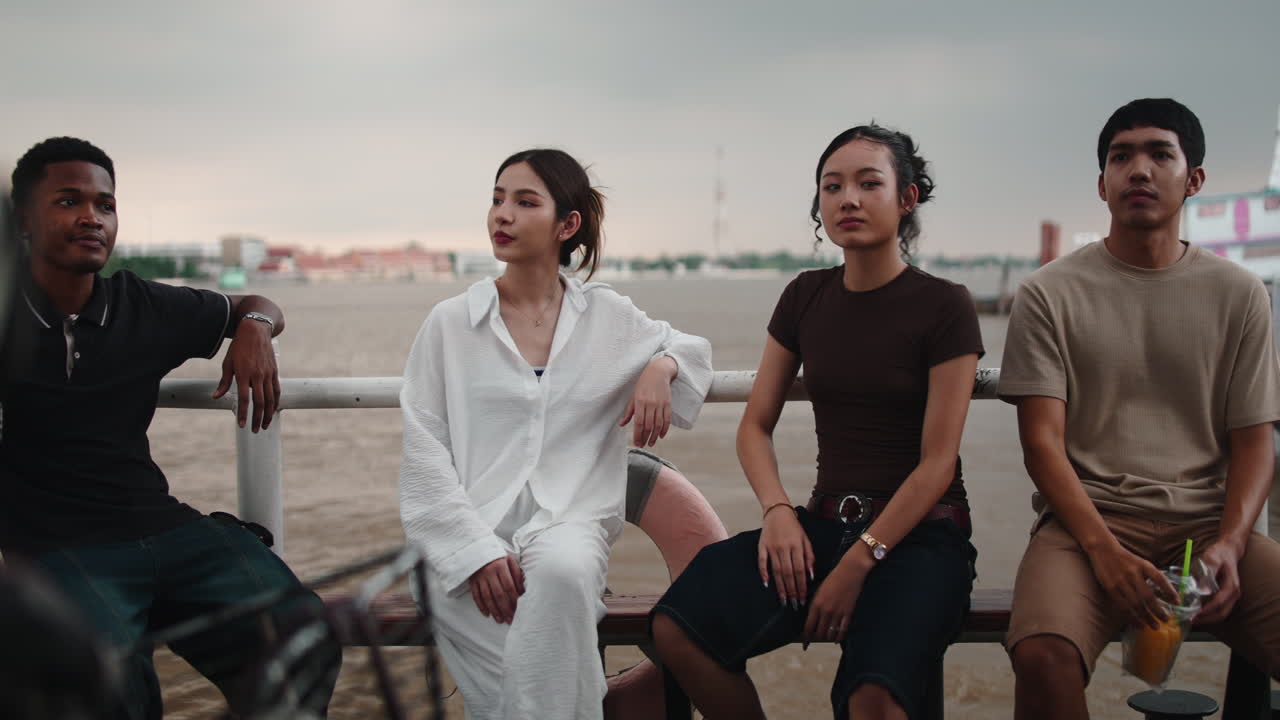 People relaxing by the river
