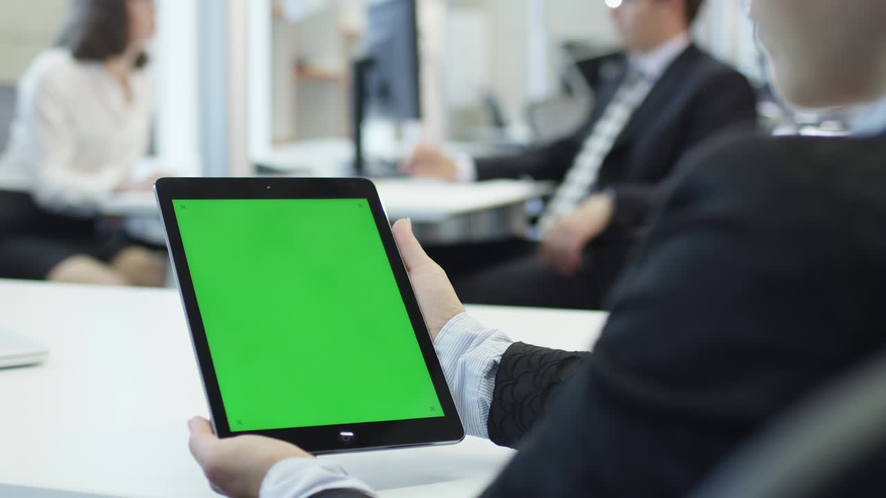 Female Woman Worker is Holding Tablet with Green Screen. Great for Mockup Usage.