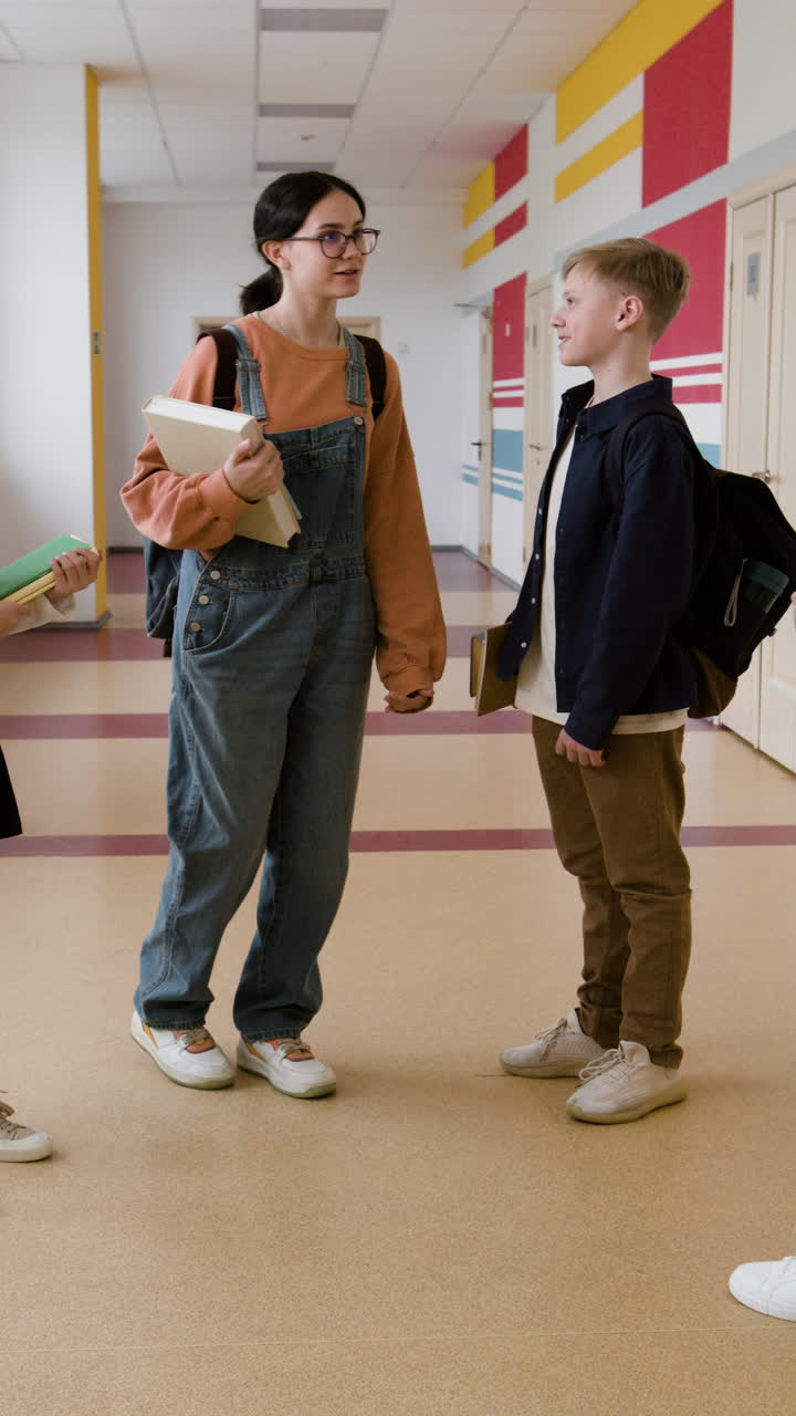 Two students talking in a school hallway