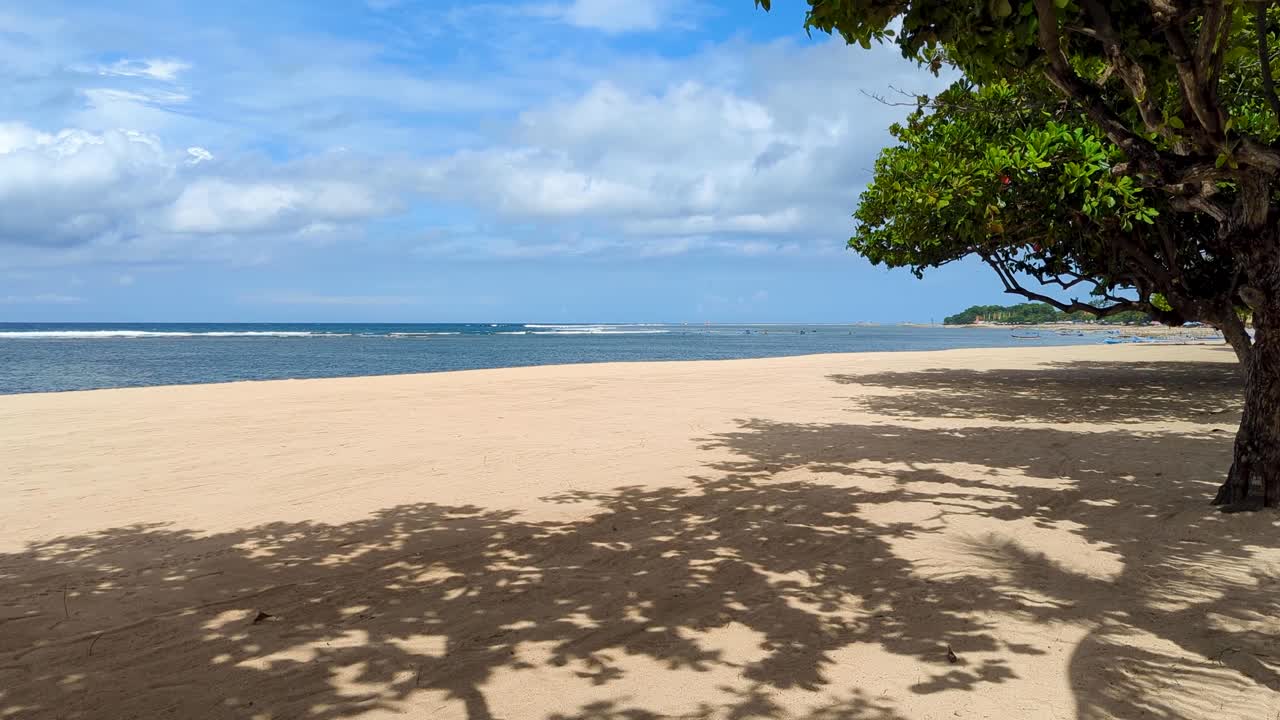Scenic view of white sandy beach empty with no people in Sanur Denpasar on tropical island of Bali, Indonesia
