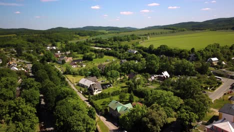 panoramic gorgeous landscape containing an idyllic czech republic village in a lush green valley in