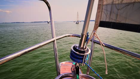 The-front-bow-of-a-white-sailing-boat-with-blue-sky-and-sea-background