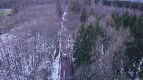 4K-SUV-DRIVES-THROUGH-FOREST-DURING-WINTER-TIME-NEAR-MEISDORF,-HARZ,-GERMANY