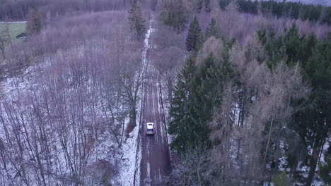 4k suv drives through forest during winter time near meisdorf, harz, germany