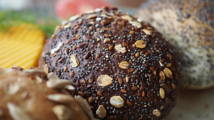 Close-up of a Dark Seeded Bread Roll with Oats and Poppy Seeds